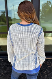 Contrast stitching sweatshirt in cream with blue trim and a subtle dot pattern.