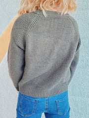 Sage cable knit raglan cardigan with ribbed texture and crew neckline.