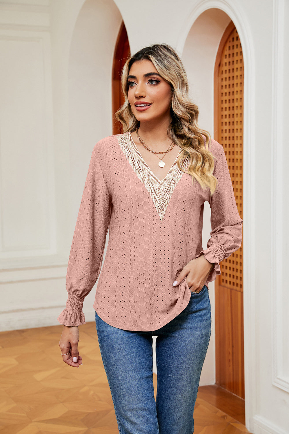 Blush pink eyelet blouse with lace V-neck and ruffle cuffs.