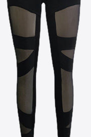 Black leggings with geometric mesh panels on the legs.