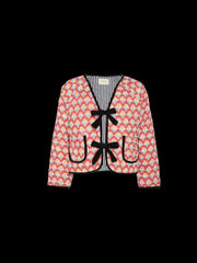 Quilted jacket with floral print, contrast trim, and bow-front closure.