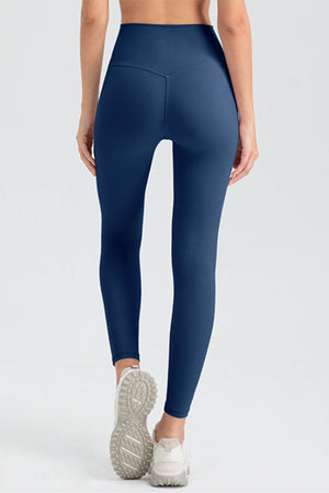 Dark blue high rise leggings with V-seam detail on back, full length