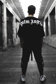 Black oversized tee with white gothic script back print, crew neck, short sleeves.