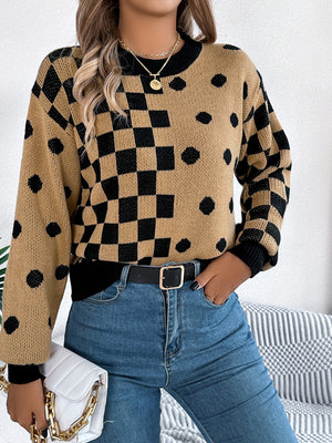 Camel checkerboard and dot intarsia knit sweater with black trim and crewneck.