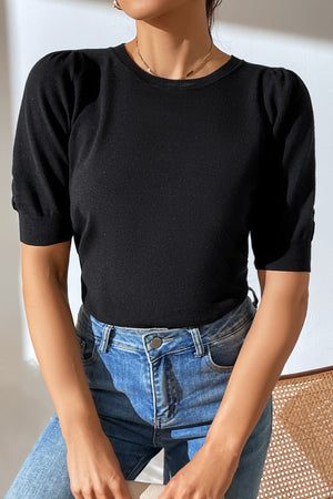 Lilac knit sweater with puff sleeves.