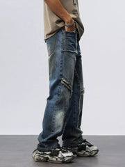 Men's blue denim wide leg jeans with frayed hem details and distressed accents.