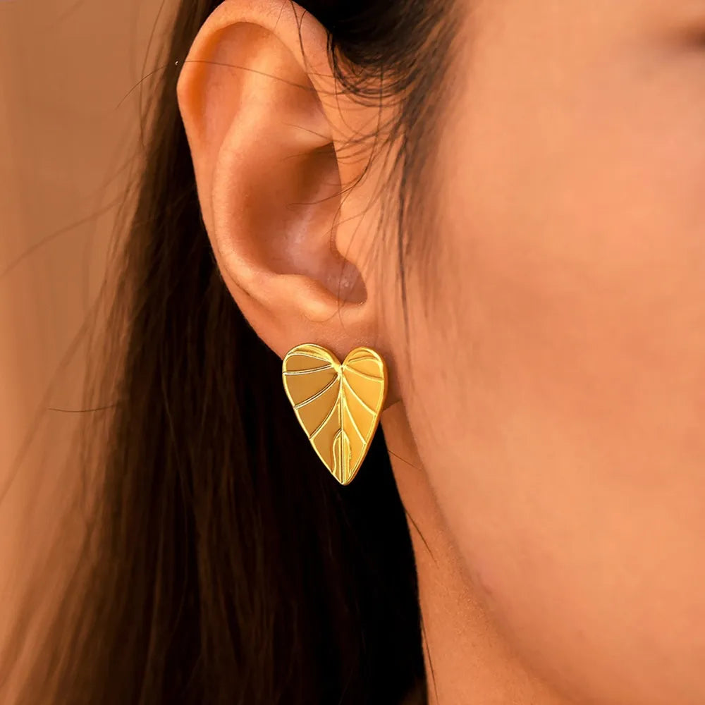 Gold heartleaf stud earrings with vein detail