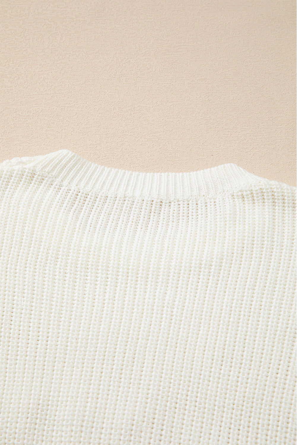 Ivory knit sweater with crew neck and ribbed texture
