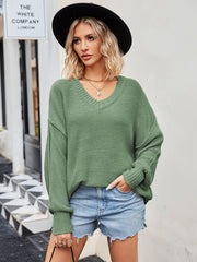Oversized slouch knit v-neck sweater in green, featuring a relaxed fit and casual style.