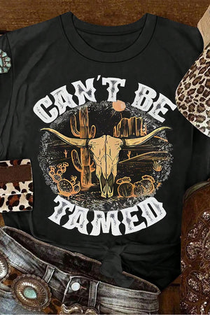 Black cotton blend graphic tee with bull skull and cactus desert scene, "Can't Be Tamed" text.