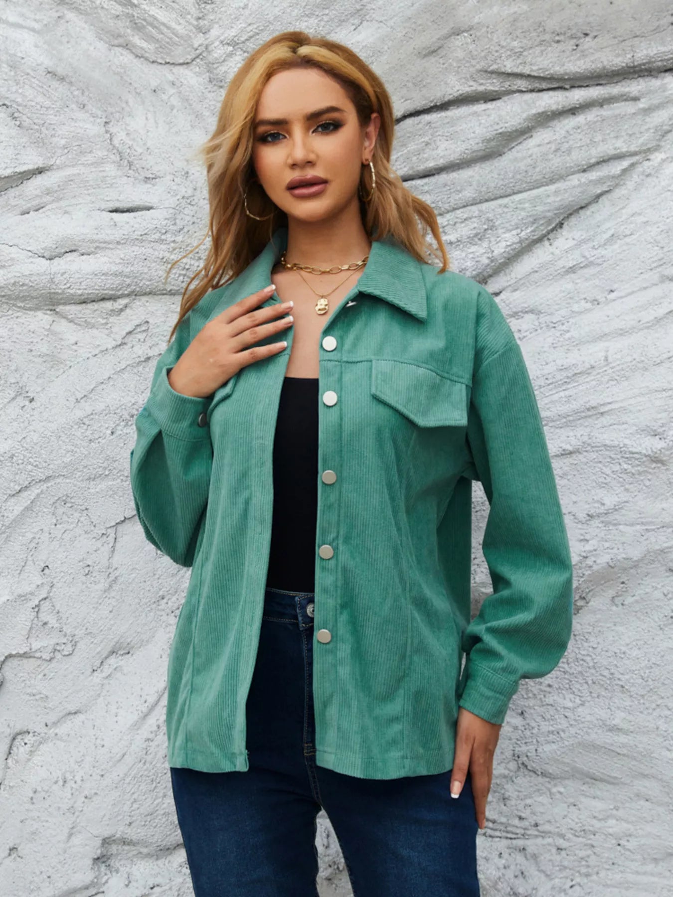 Textured corduroy button-up jacket in Peacock Green with chest pockets and silver buttons.