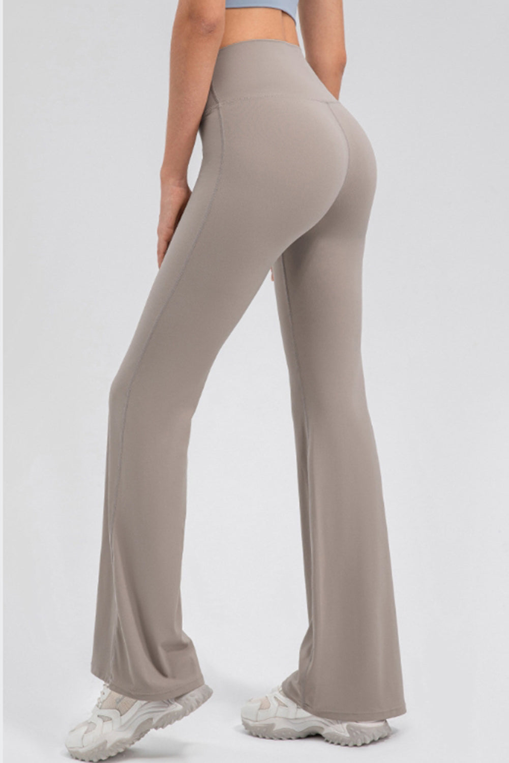 Tan sculpted flare leggings with a high waist and performance fit.