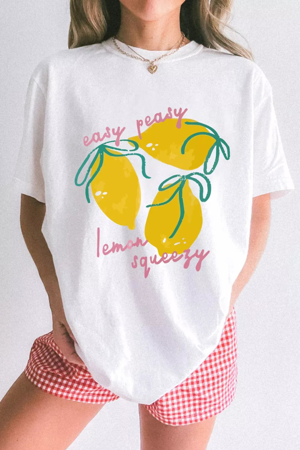 White polyester t-shirt with a graphic of three yellow lemons and the text easy peasy lemon squeezy.