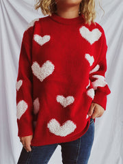 Red acrylic sweater with textured white heart appliqués and crew neck.