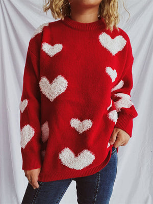 Red acrylic sweater with textured white heart appliqués and crew neck.