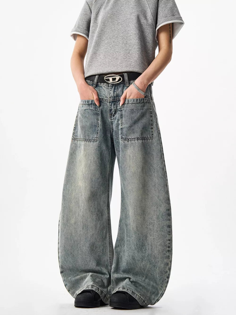 Belted wide-leg blue denim jeans with large front pockets and a washed finish.