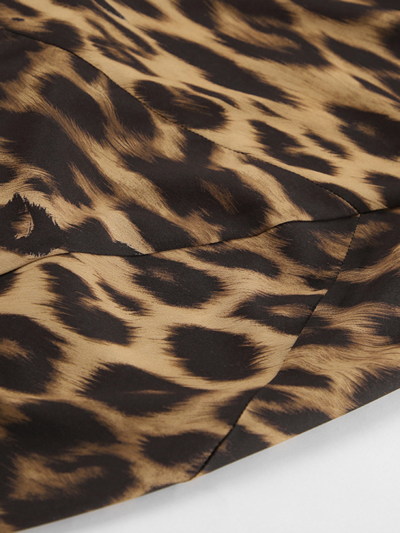 Print bodycon maxi skirt in leopard print fabric with a close-up detail of the seams.