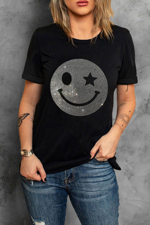 Black t-shirt with rhinestone smiley face graphic and rolled sleeves.