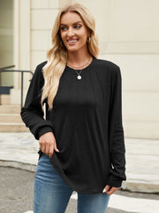 Black crew neck long sleeve top with vertical seam detail and curved hem