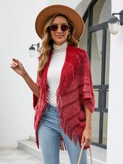 Textured fringe capelet in wine with striped pattern and open front, styled with a turtleneck and jeans.