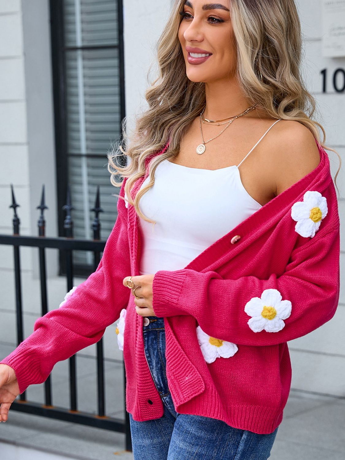Watermelon pink V-neck cardigan with daisy appliqués and button front.