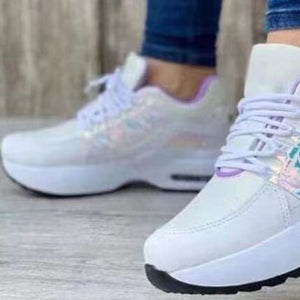 White lace-up chunky platform sneakers with iridescent accents and purple trim.