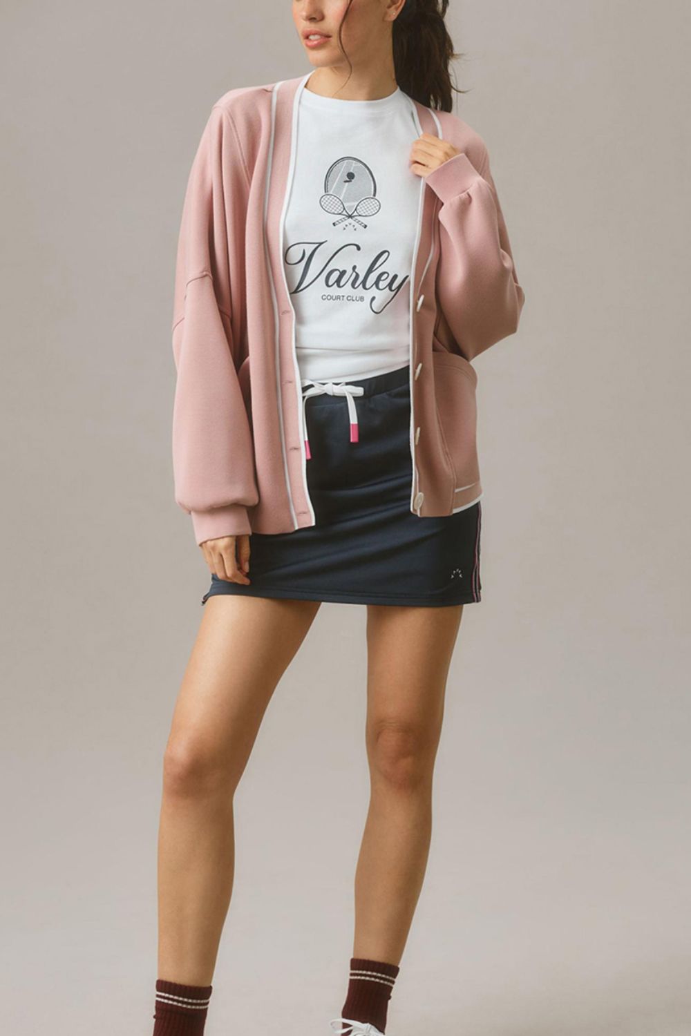 Dusty pink buttoned cocoon cardigan with white trim, open front, and pockets.