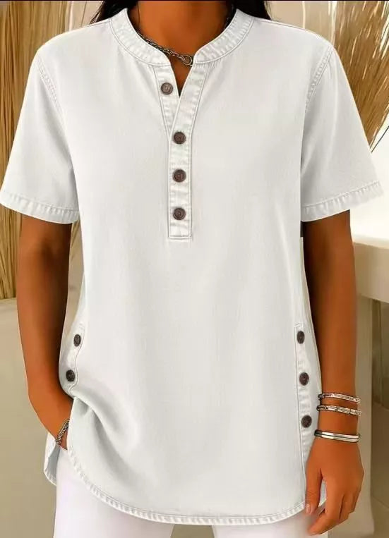Light blue denim-inspired short sleeve button blouse with band collar and side button detail.