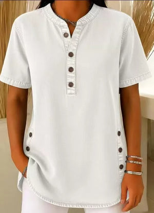 Light blue denim-inspired short sleeve button blouse with band collar and side button detail.