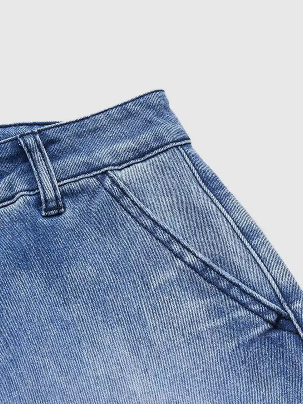 Relaxed high-waisted denim maternity jeans in light blue with pockets and cuffed hem detail.