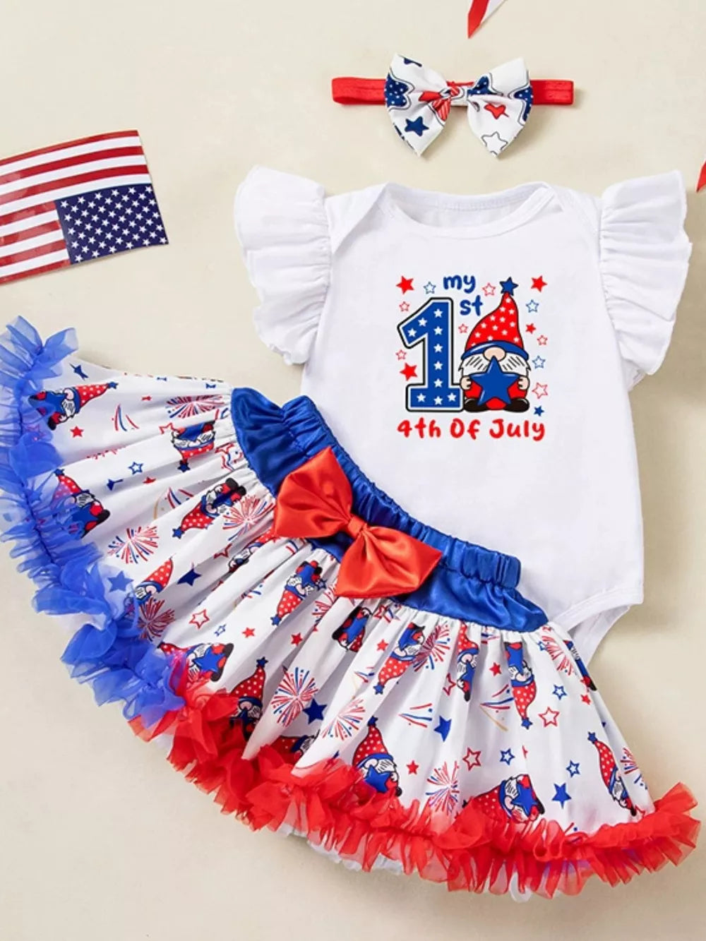 Baby 4th of July outfit set with gnome print skirt and ruffled trim, white bodysuit with "my 1st 4th Of July" graphic.