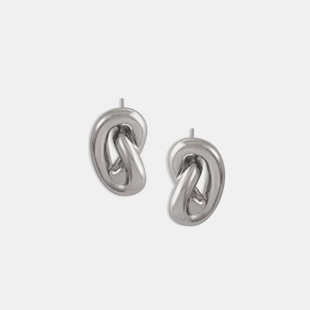 Sculptural knot stud earrings in silver with a polished finish.