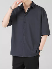 Men's dark gray short sleeve button-down shirt with spread collar.