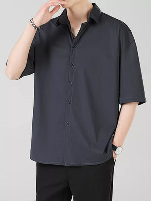 Men's dark gray short sleeve button-down shirt with spread collar.