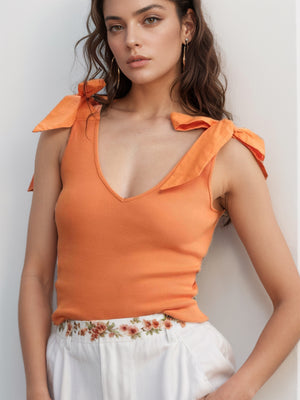 Orange ribbed knit tank top with bow shoulder detail and V-neck