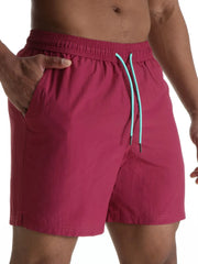 Deep Purple swim shorts with contrast teal drawcord and elastic waistband.