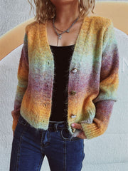 Ombre knit cardigan with heart buttons and a V-neck, featuring multicolor hues of orange, yellow, and purple.