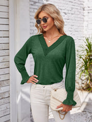 Dark green blouson sleeve top with lace trim V-neck and smocked cuffs.