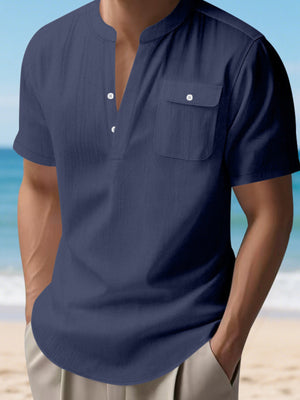 Navy blue short sleeve henley shirt with band collar and chest pocket.