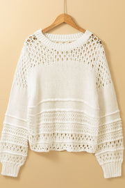 Ivory openwork knit pullover sweater with balloon sleeves and textured details.