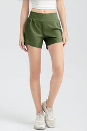 Layered performance running shorts in matcha green with elastic waistband and curved hem.