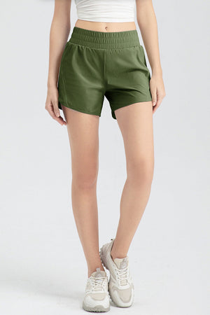 Layered performance running shorts in matcha green with elastic waistband and curved hem.