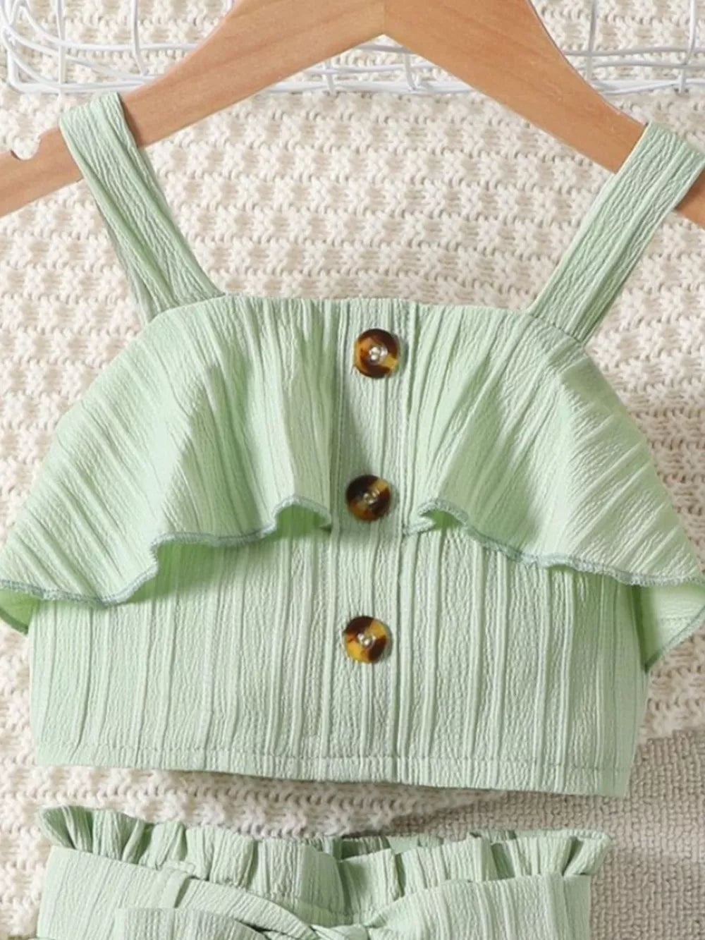 Light green ribbed toddler set with ruffled top and button detail.