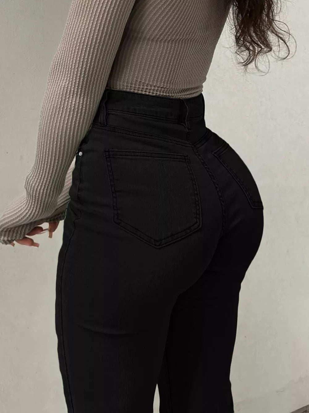Black denim maternity jeans with pockets and a sculpted flare leg.