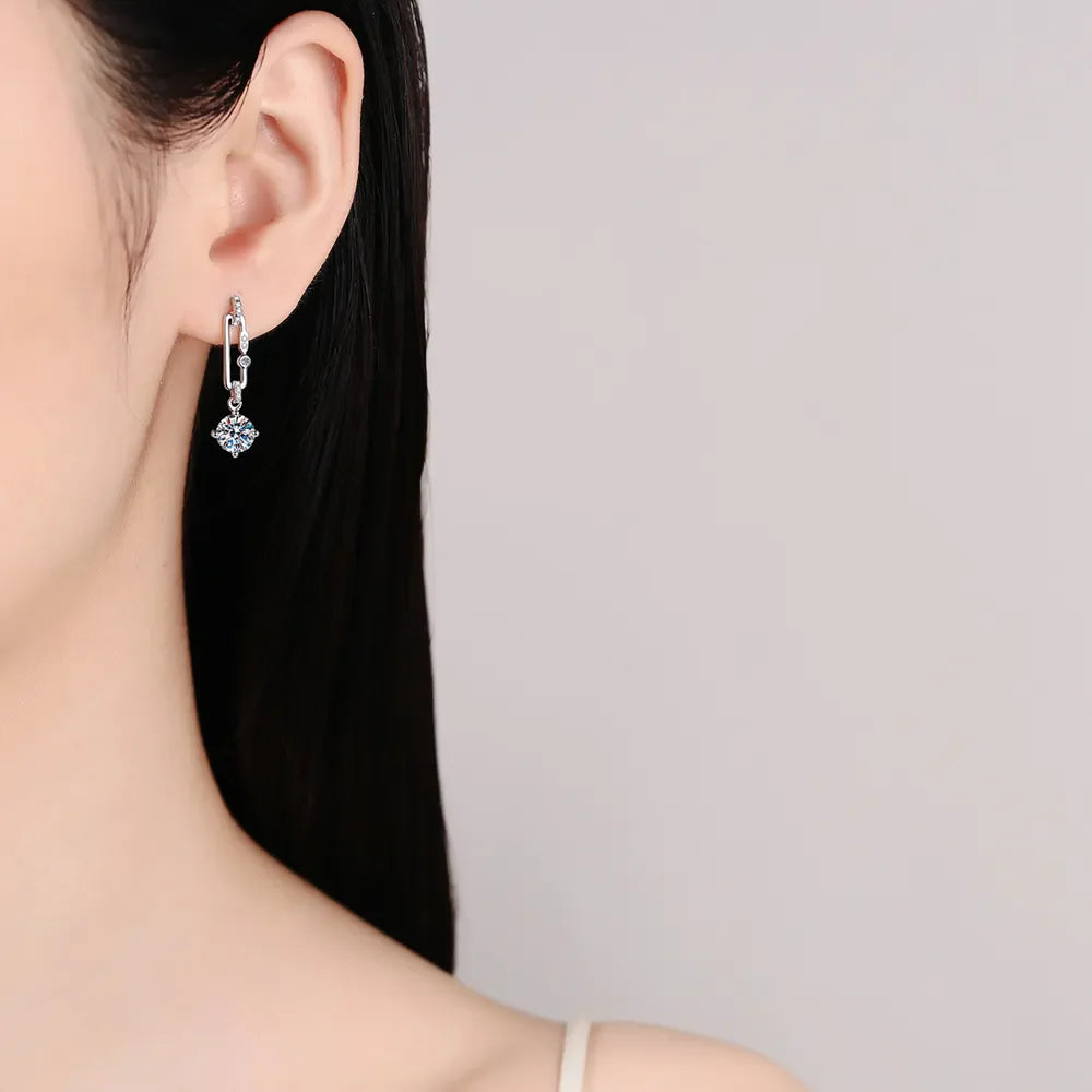 Silver link moissanite drop earrings with a single round cut stone.