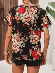 Women's black t-shirt with abstract floral print, short sleeves, and keyhole back detail.