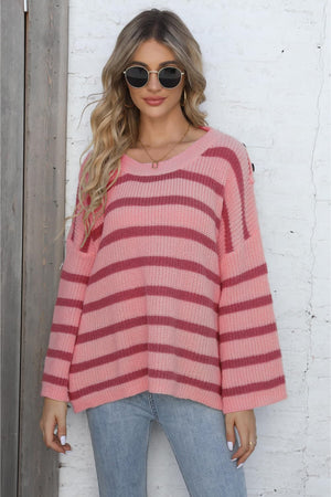 Pink striped knit pullover sweater with button shoulder detail and crew neck.