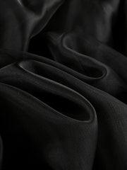 Black midi skirt with sheer overlay, draped fabric detail