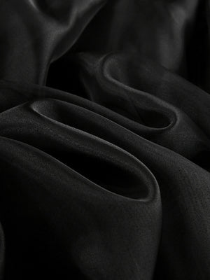 Black midi skirt with sheer overlay, draped fabric detail