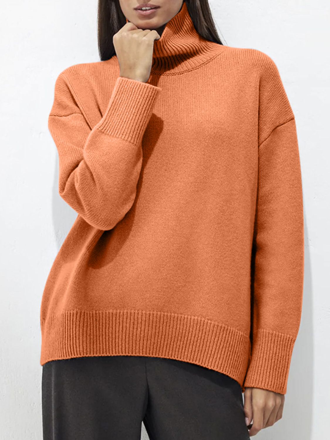 Orange ribbed turtleneck sweater with relaxed fit and ribbed cuffs and hem.